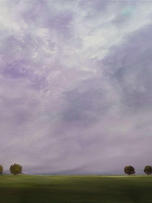 Landscape with green field and trees under a purple sky