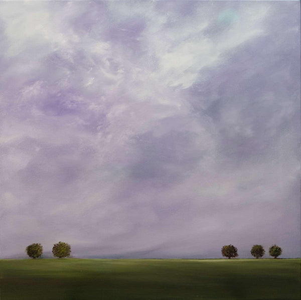 Landscape with green field and trees under a purple sky