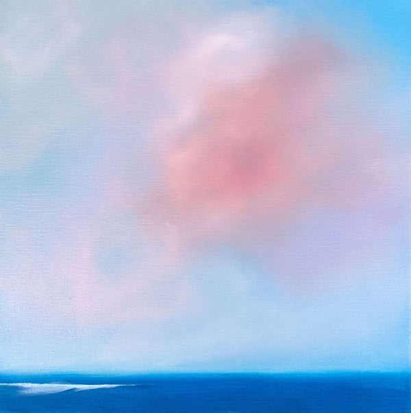 Abstract seascape and clouds of pink, and purple hues against blue sky