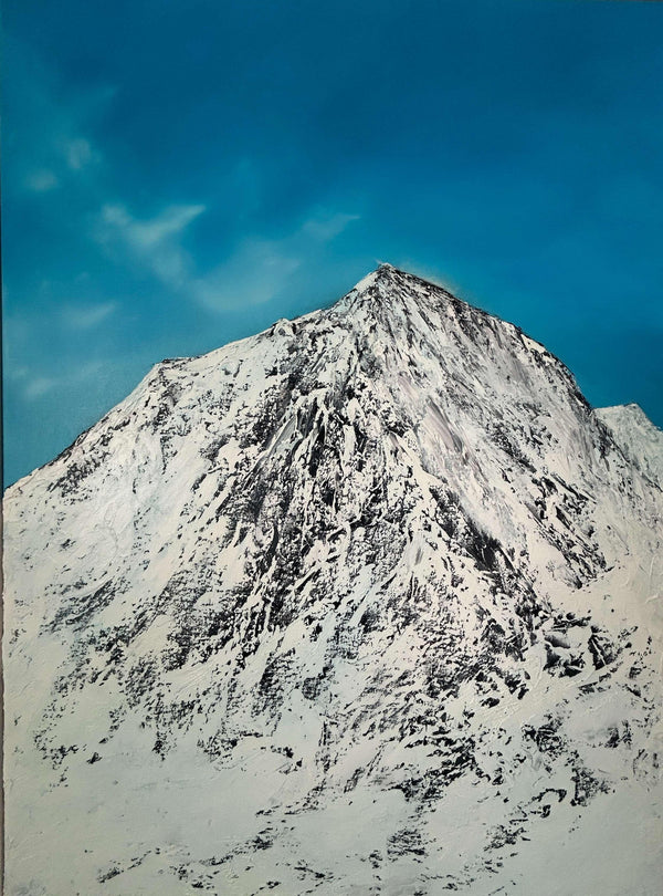 Snow-covered mountain peak under a clear blue sky