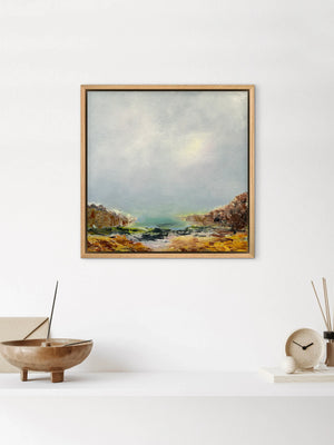 Framed landscape painting on a white wall with decorative items below.