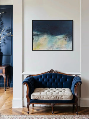Abstract coastal painting over Navy blue tufted sofa