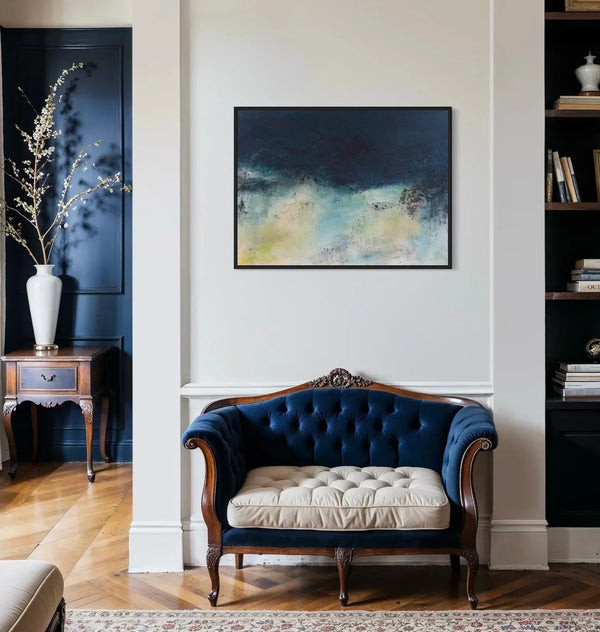 Abstract coastal painting over Navy blue tufted sofa